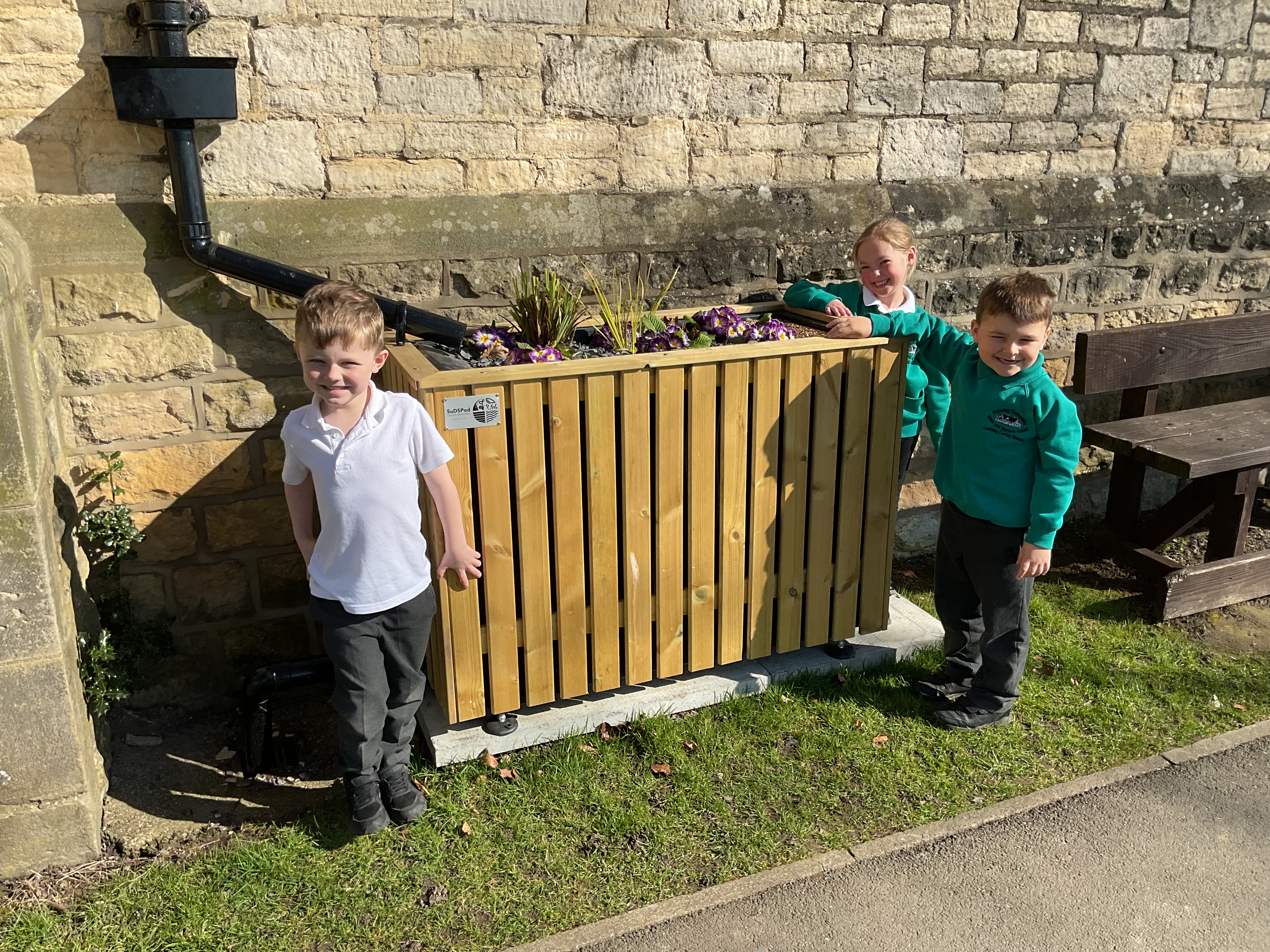 Pickering Community Infant and Nursery School children in front of SuDS planter