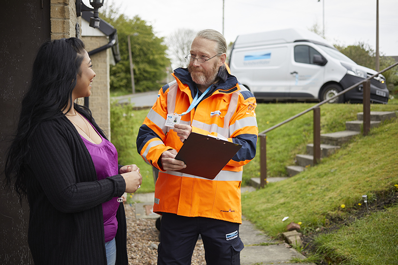 Leakage inspector talking to a customer