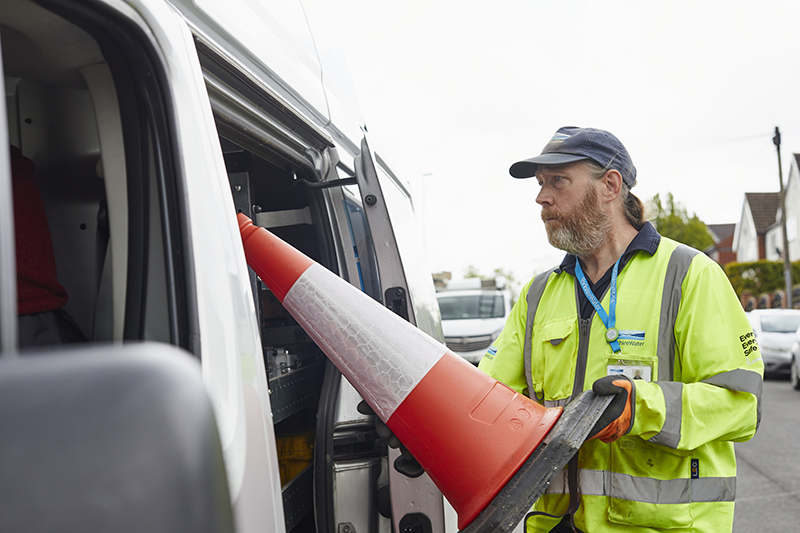 Leakage inspector loading equiptment into the van