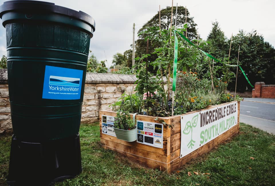Yorkshire Water water butt next to Incredible Edible South Milford raised planter
