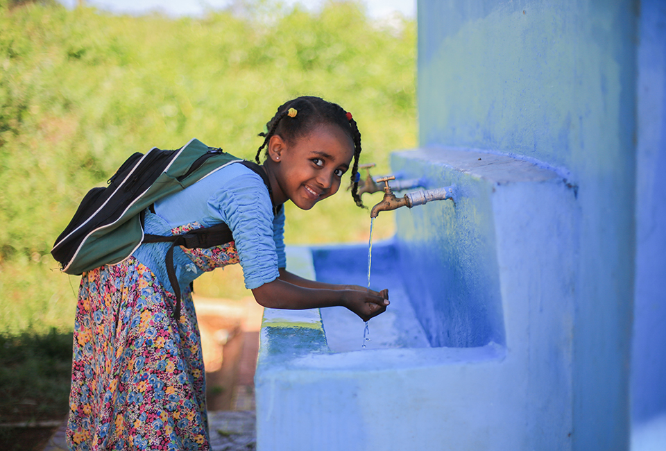 Tigist, 7, washes her hands at the new taps at Edget Bihibret Elementary School, Burie, West Gojjam, Amhara, Ethiopia. November 2018.