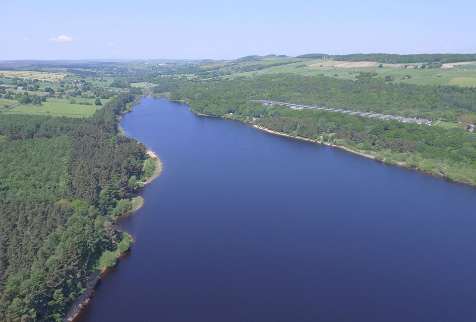 A drone image of Underbank reservoir taken on a sunny day