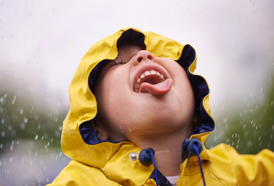 Little boy catching rain in his mouth