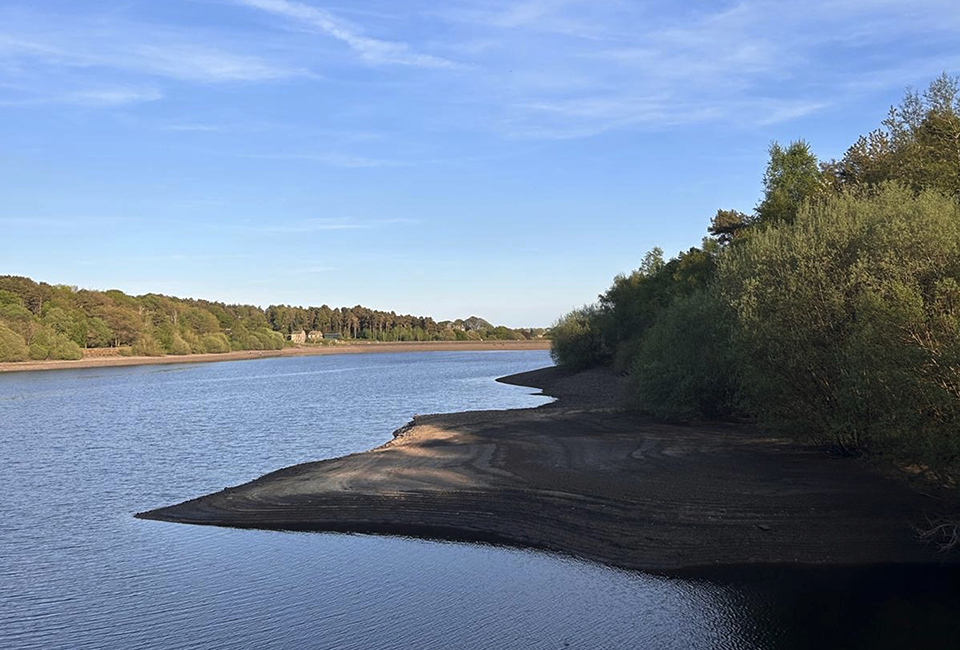 A reservoir with bank exposed due to low levels