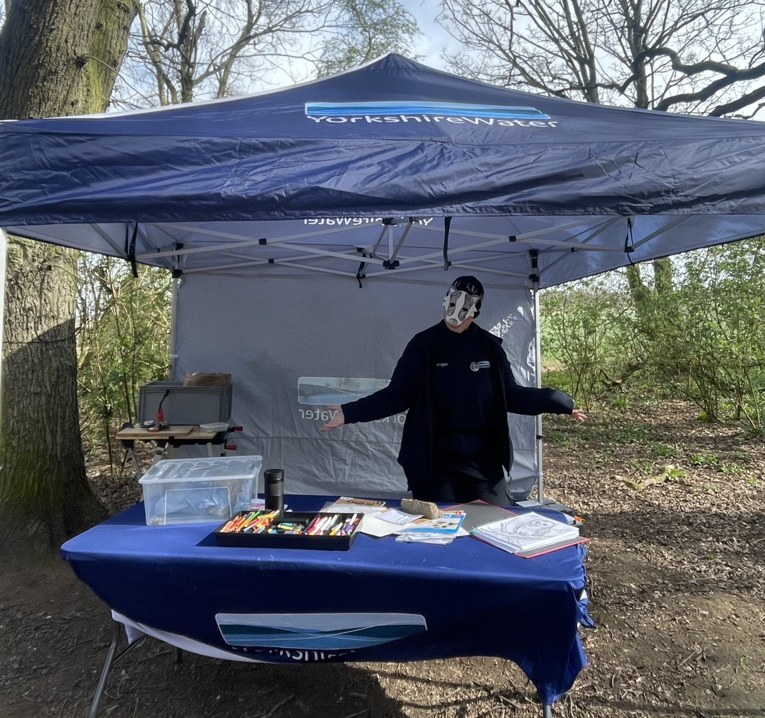YW colleague in Easter bunny mask stood by gazebo in a woodland