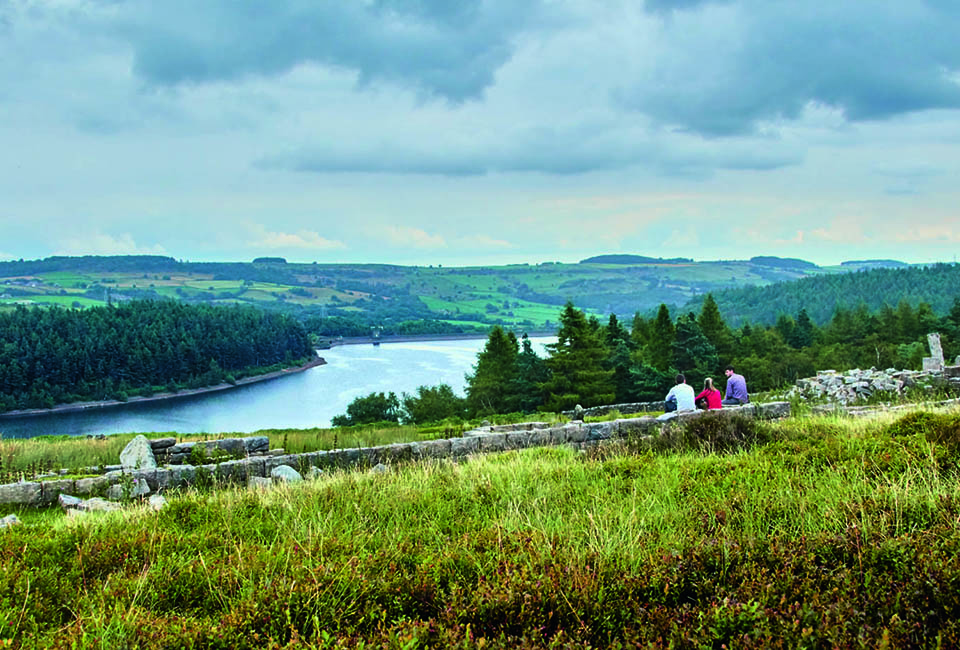 Beautiful blue reservoir under a blue summer sky with white clouds dotted in it