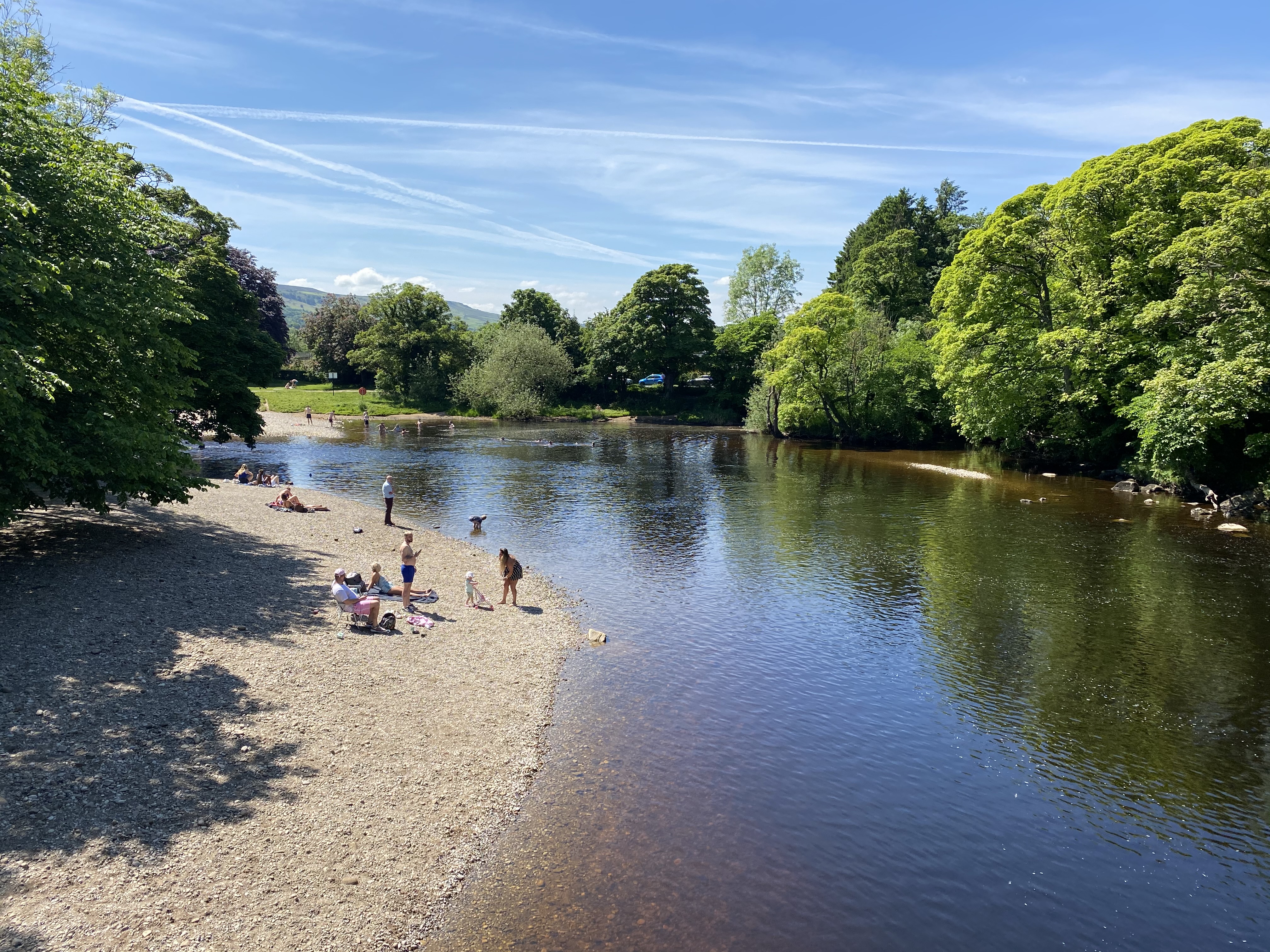 aerial shot of the River Wharfe with trees and clouds reflected in the blue surface of the water