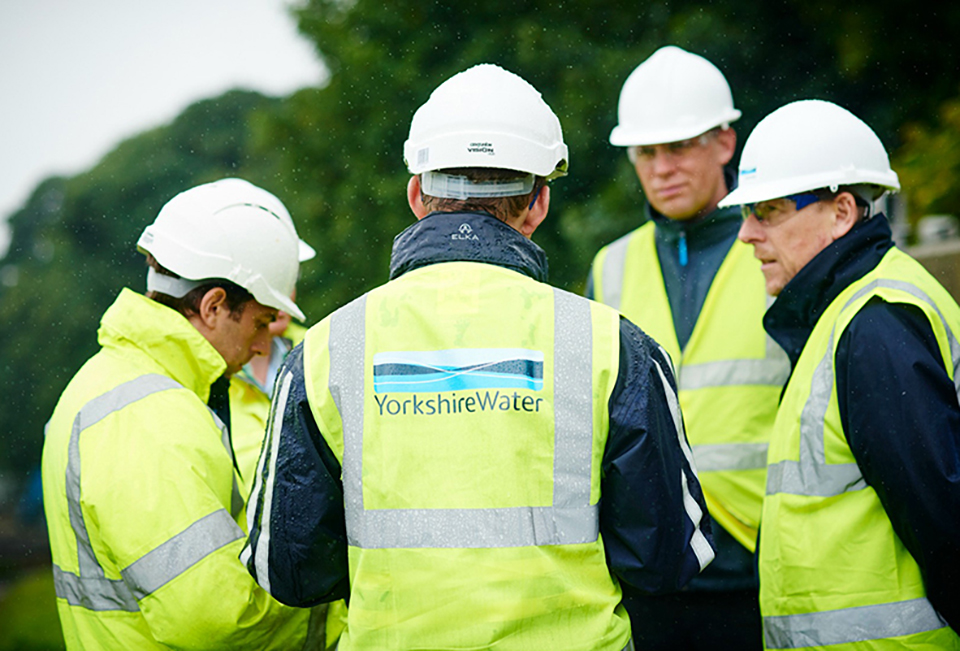 A group of Yorkshire Water innovation colleagues talking about a new pipe lining solution