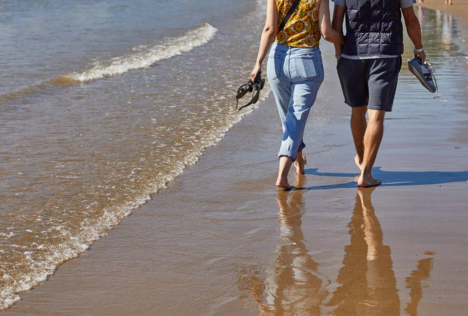 Couple walking along Scarborough beach