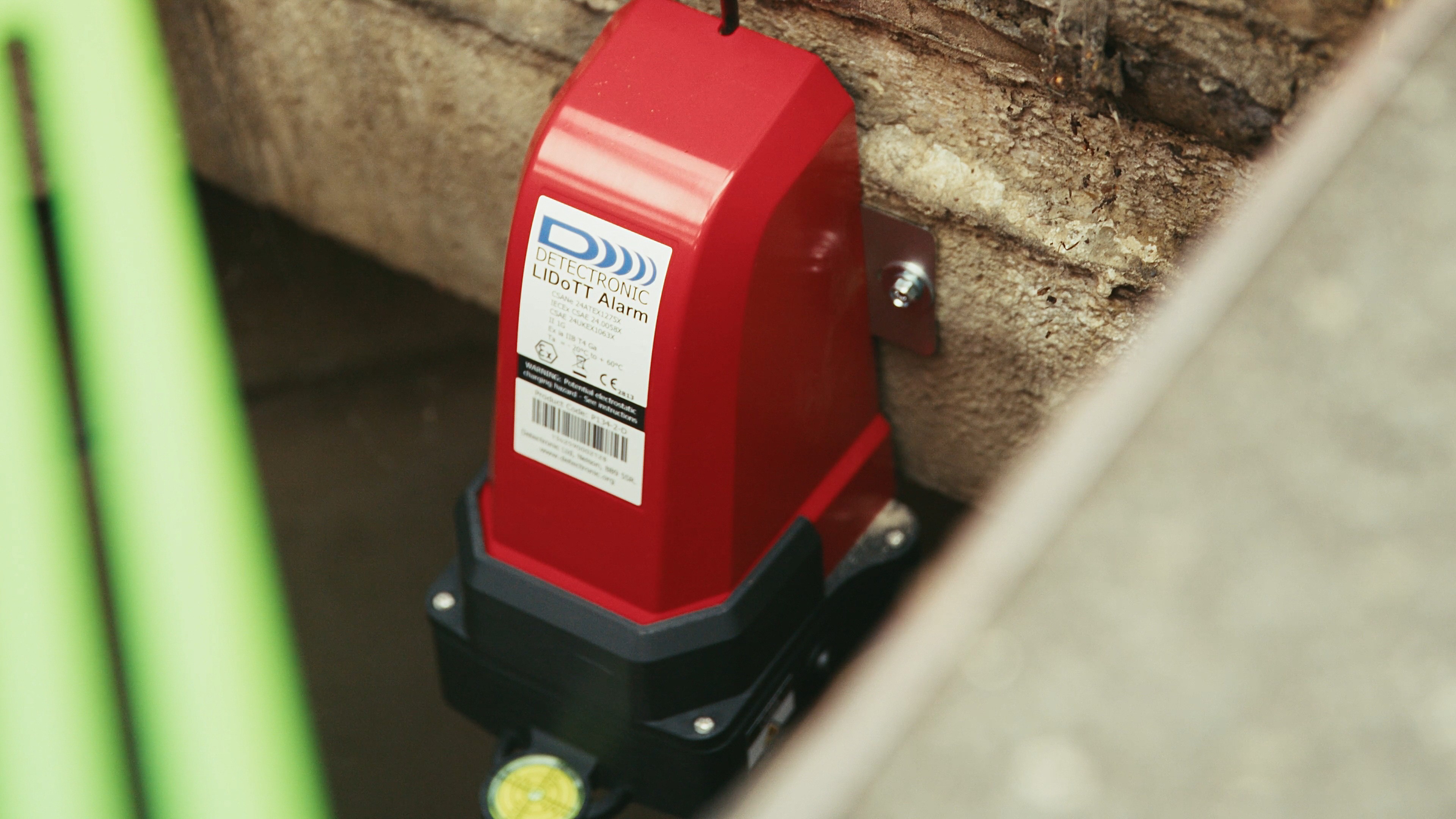Close up of red sewer monitoring equipment in place