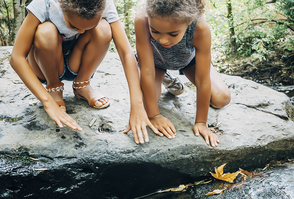 Girls by a stream 