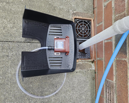 Sewer alarm attached to a leaf cover