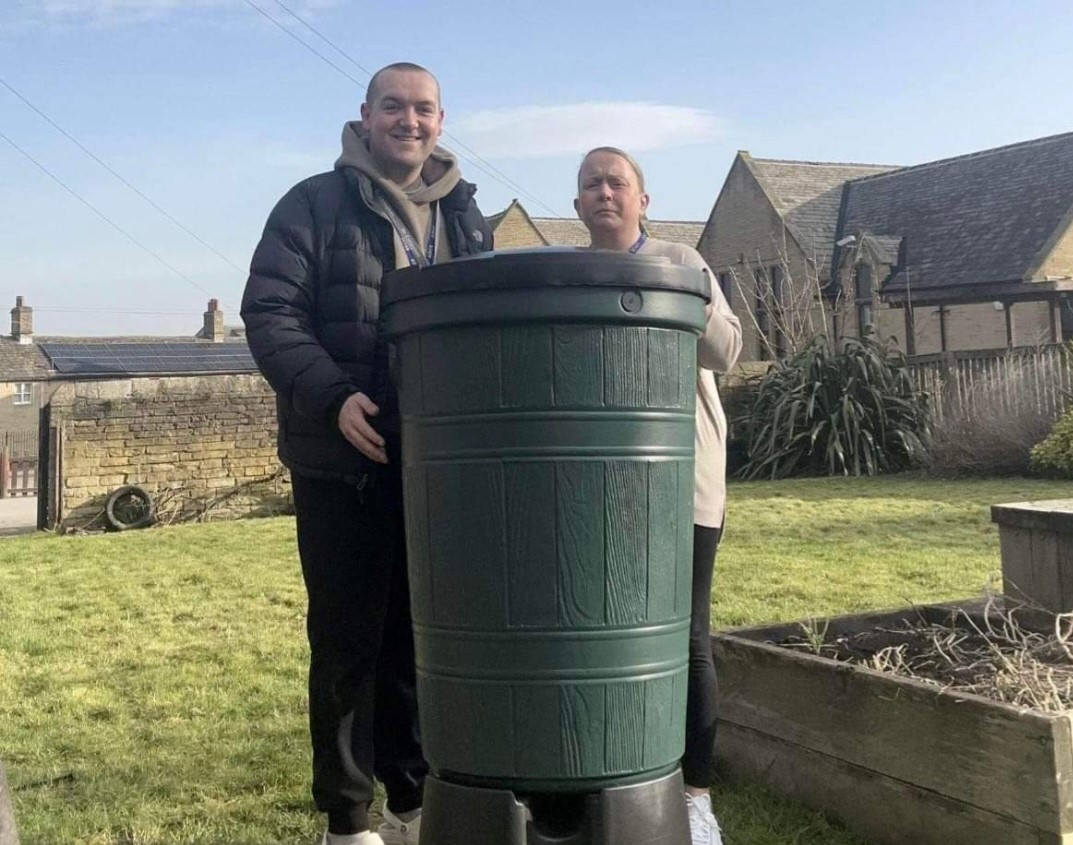 Mr Callaghan and Miss Brook of Thorpe Primary School with water butt donated by Yorkshire Water