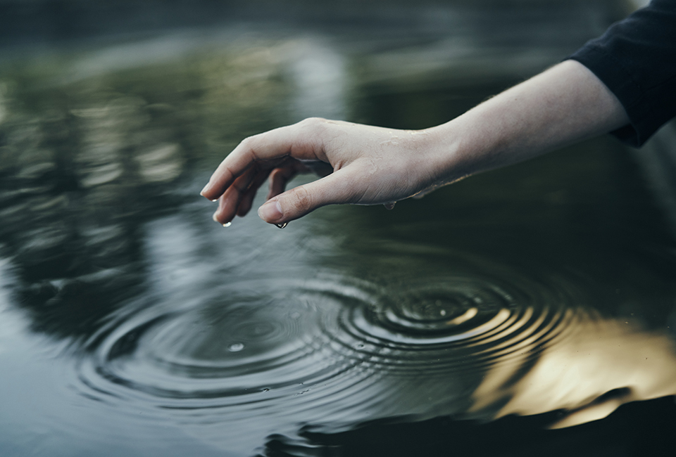 Hand touching water