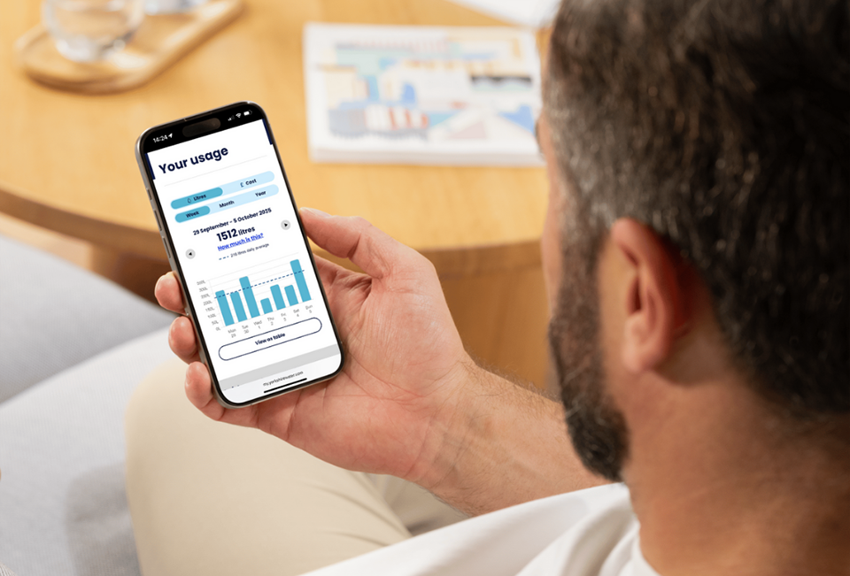 A Yorkshire Water customer using his mobile to view her online account and check his smart meter readings.