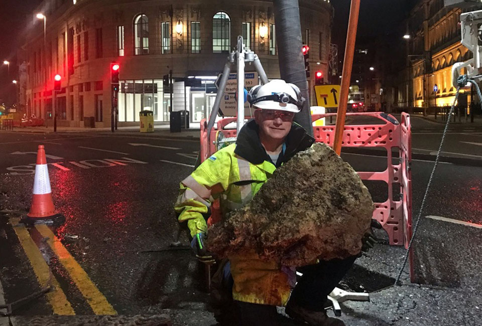 Yorkshire Water colleague holding a large piece of a fatberg in Leeds city centre