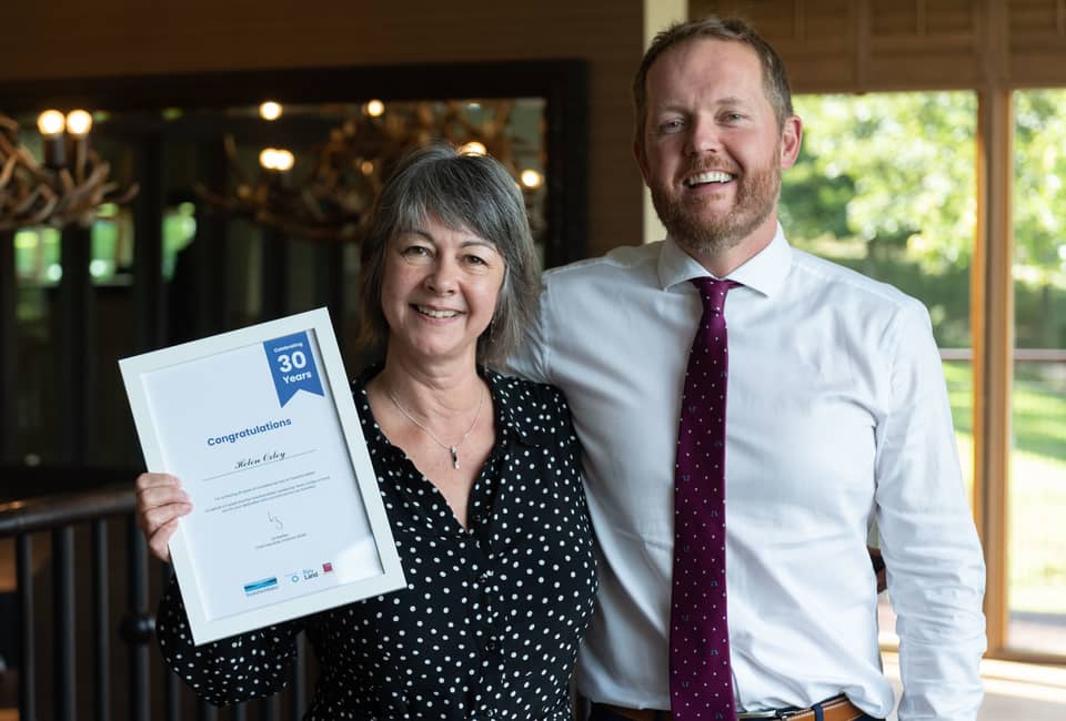 YW employee Helen Oxley celebrates 30 years service with director of waste water service, Ben Roche.