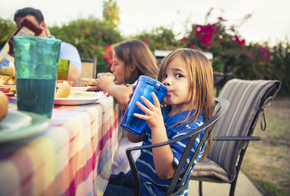 Little girl having a big drink