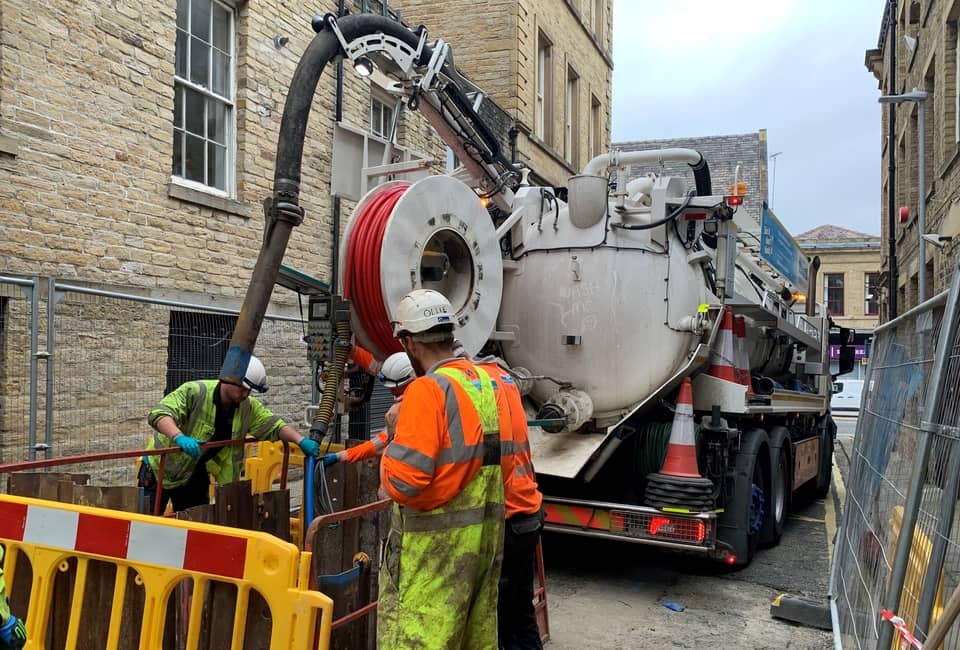 Yorkshire Water teams using vehicle to remove blockage from a Huddersfield sewer